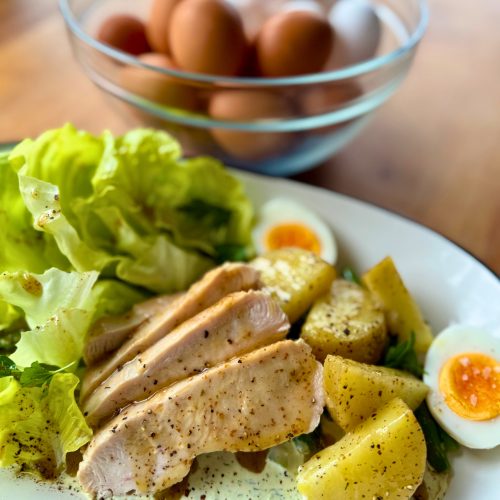 BC Turkey and BC Egg Cobb salad with sliced turkey breast, hard-boiled eggs, avocado, bacon, and tomatoes on a bed of local greens